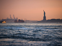  Sunset over the East River and a view on the Statue of Liberty in New York City, United States of America on July 7th, 2024.  (