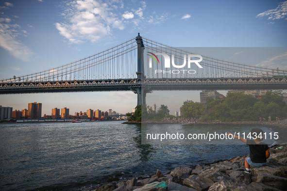  A view on Manhattan Bridge and Pebble Beach in New York City, United States of America on July 7th, 2024.  