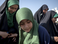 Young veiled schoolgirls are arriving to participate in a gathering to support mandatory hijab at the Azadi (Freedom) Stadium in western Teh...