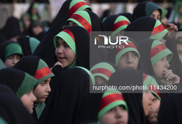 Young veiled schoolgirls are wearing religious headbands and are participating in a gathering to support mandatory hijab at the Azadi (Freed...