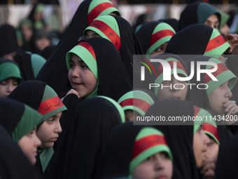 Young veiled schoolgirls are wearing religious headbands and are participating in a gathering to support mandatory hijab at the Azadi (Freed...