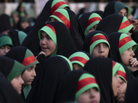 Young veiled schoolgirls are wearing religious headbands and are participating in a gathering to support mandatory hijab at the Azadi (Freed...