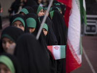 A young veiled Iranian schoolgirl is looking on while participating in a gathering to support mandatory hijab at the Azadi (Freedom) Stadium...