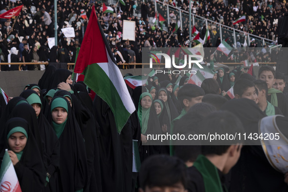 Young veiled schoolgirls and schoolboys are participating in a gathering to support mandatory hijab at the Azadi (Freedom) Stadium in Tehran...