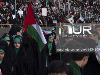 Young veiled schoolgirls and schoolboys are participating in a gathering to support mandatory hijab at the Azadi (Freedom) Stadium in Tehran...