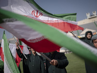 Young schoolboys are waving Iranian flags while participating in a gathering to support mandatory hijab at the Azadi (Freedom) Stadium in we...