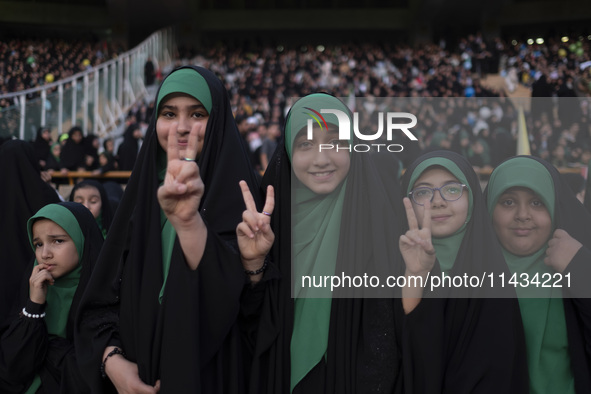 Young veiled Iranian schoolgirls are flashing Victory signs while participating in a gathering to support mandatory hijab at the Azadi (Free...