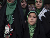 A young veiled Iranian schoolgirl is looking on while participating in a gathering to support mandatory hijab at the Azadi (Freedom) Stadium...