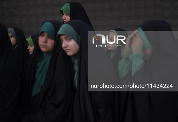 Young veiled Iranian schoolgirls are participating in a gathering to support mandatory hijab at the Azadi (Freedom) Stadium in western Tehra...