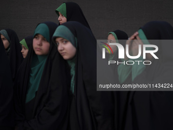 Young veiled Iranian schoolgirls are participating in a gathering to support mandatory hijab at the Azadi (Freedom) Stadium in western Tehra...