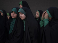 Young veiled Iranian schoolgirls are participating in a gathering to support mandatory hijab at the Azadi (Freedom) Stadium in western Tehra...