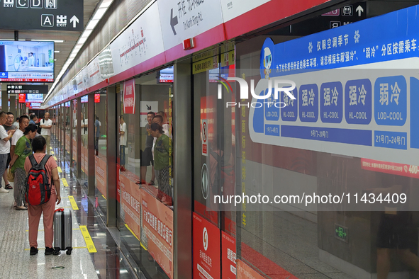 A strong cold and weak cold ''double warm carriage'' sign is being seen at a subway station in Changchun, China, on July 17, 2024. In recent...