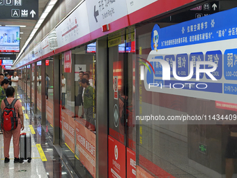 A strong cold and weak cold ''double warm carriage'' sign is being seen at a subway station in Changchun, China, on July 17, 2024. In recent...