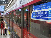 A strong cold and weak cold ''double warm carriage'' sign is being seen at a subway station in Changchun, China, on July 17, 2024. In recent...