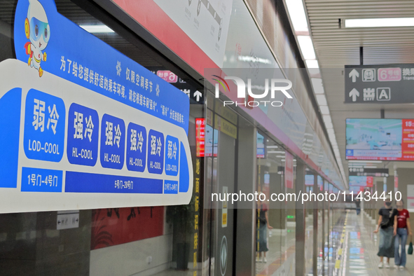 A strong cold and weak cold ''double warm carriage'' sign is being seen at a subway station in Changchun, China, on July 17, 2024. In recent...