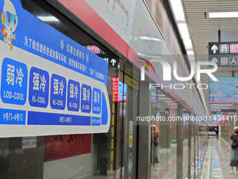 A strong cold and weak cold ''double warm carriage'' sign is being seen at a subway station in Changchun, China, on July 17, 2024. In recent...