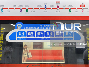 A strong cold and weak cold ''double warm carriage'' sign is being seen at a subway station in Changchun, China, on July 17, 2024. In recent...