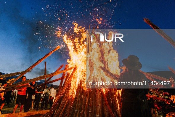 People are celebrating the Torch Festival at Torch Square in Butuo county, Liangshan Yi autonomous prefecture, in Sichuan, China, on July 22...