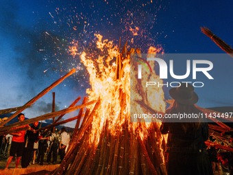 People are celebrating the Torch Festival at Torch Square in Butuo county, Liangshan Yi autonomous prefecture, in Sichuan, China, on July 22...