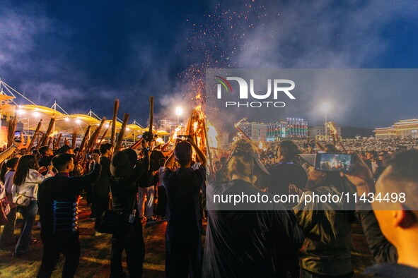 People are celebrating the Torch Festival at Torch Square in Butuo county, Liangshan Yi autonomous prefecture, in Sichuan, China, on July 22...