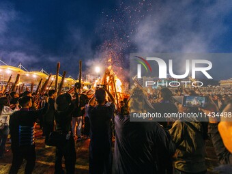 People are celebrating the Torch Festival at Torch Square in Butuo county, Liangshan Yi autonomous prefecture, in Sichuan, China, on July 22...