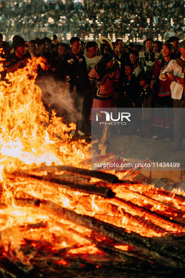 People are celebrating the Torch Festival at Torch Square in Butuo county, Liangshan Yi autonomous prefecture, in Sichuan, China, on July 22...