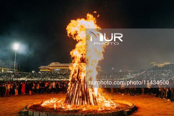 People are celebrating the Torch Festival at Torch Square in Butuo county, Liangshan Yi autonomous prefecture, in Sichuan, China, on July 22...