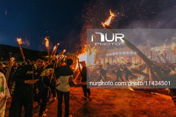 People are celebrating the Torch Festival at Torch Square in Butuo county, Liangshan Yi autonomous prefecture, in Sichuan, China, on July 22...