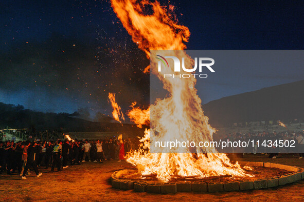 People are celebrating the Torch Festival at Torch Square in Butuo county, Liangshan Yi autonomous prefecture, in Sichuan, China, on July 22...