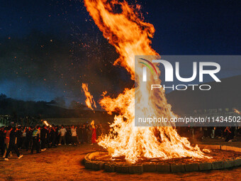 People are celebrating the Torch Festival at Torch Square in Butuo county, Liangshan Yi autonomous prefecture, in Sichuan, China, on July 22...