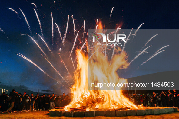 People are celebrating the Torch Festival at Torch Square in Butuo county, Liangshan Yi autonomous prefecture, in Sichuan, China, on July 22...