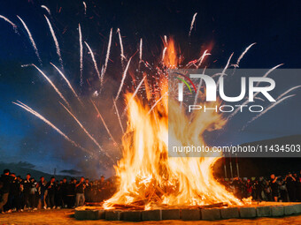 People are celebrating the Torch Festival at Torch Square in Butuo county, Liangshan Yi autonomous prefecture, in Sichuan, China, on July 22...