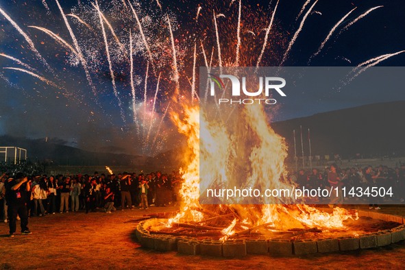 People are celebrating the Torch Festival at Torch Square in Butuo county, Liangshan Yi autonomous prefecture, in Sichuan, China, on July 22...