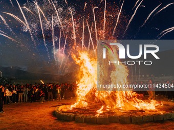 People are celebrating the Torch Festival at Torch Square in Butuo county, Liangshan Yi autonomous prefecture, in Sichuan, China, on July 22...