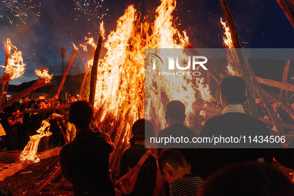 People are celebrating the Torch Festival at Torch Square in Butuo county, Liangshan Yi autonomous prefecture, in Sichuan, China, on July 22...