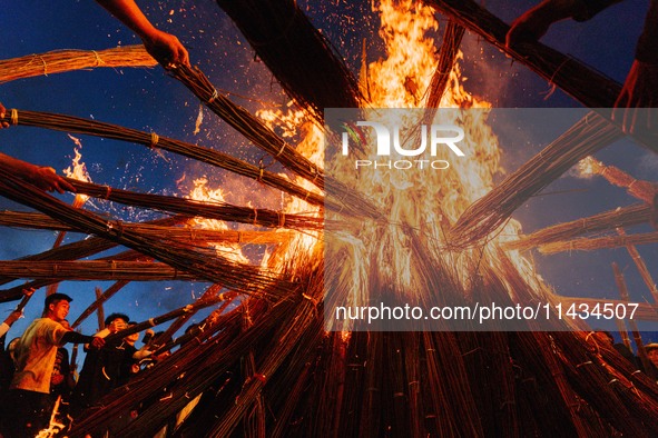 People are celebrating the Torch Festival at Torch Square in Butuo county, Liangshan Yi autonomous prefecture, in Sichuan, China, on July 22...