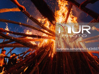 People are celebrating the Torch Festival at Torch Square in Butuo county, Liangshan Yi autonomous prefecture, in Sichuan, China, on July 22...