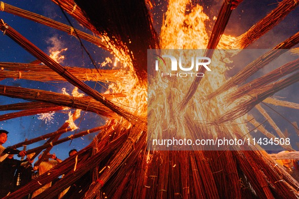 People are celebrating the Torch Festival at Torch Square in Butuo county, Liangshan Yi autonomous prefecture, in Sichuan, China, on July 22...