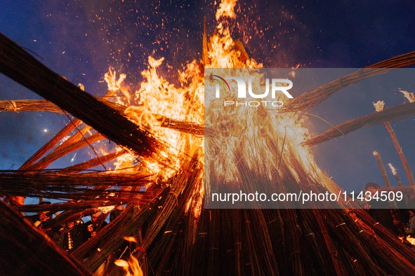 People are celebrating the Torch Festival at Torch Square in Butuo county, Liangshan Yi autonomous prefecture, in Sichuan, China, on July 22...