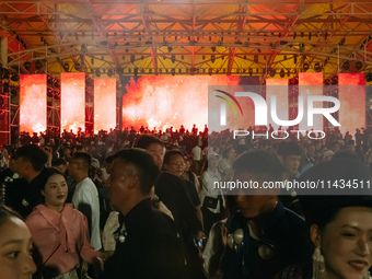 People are celebrating the Torch Festival at Torch Square in Butuo county, Liangshan Yi autonomous prefecture, in Sichuan, China, on July 22...