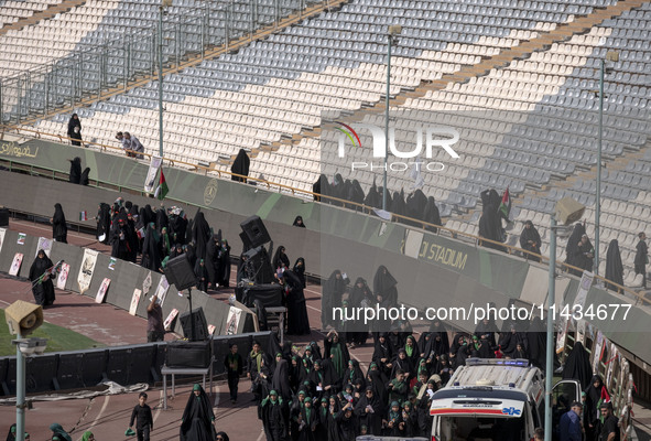 Veiled Iranian women are arriving to participate in a family rally to support mandatory hijab at the Azadi (Freedom) Stadium in western Tehr...