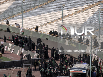 Veiled Iranian women are arriving to participate in a family rally to support mandatory hijab at the Azadi (Freedom) Stadium in western Tehr...