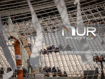 Religious headbands are being tied on a soccer goal, while veiled Iranian women are participating in a family rally to support mandatory hij...