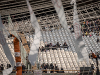 Religious headbands are being tied on a soccer goal, while veiled Iranian women are participating in a family rally to support mandatory hij...