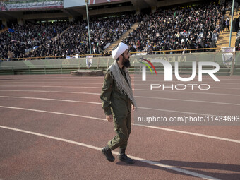 An Iranian cleric is looking at veiled women who are participating in a family rally to support mandatory hijab, at the Azadi (Freedom) Stad...