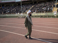 An Iranian cleric is looking at veiled women who are participating in a family rally to support mandatory hijab, at the Azadi (Freedom) Stad...