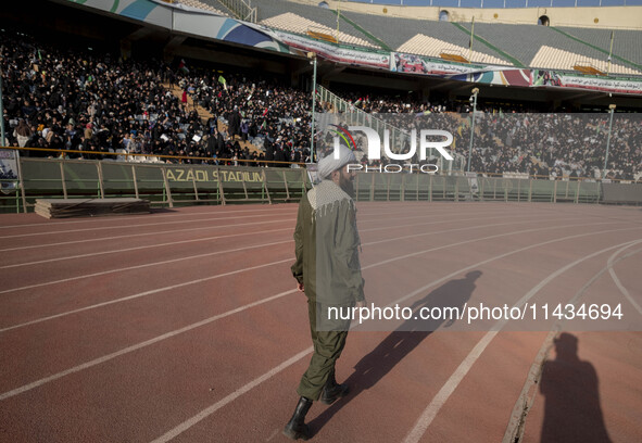 An Iranian cleric is walking along an area while veiled Iranian women are participating in a family rally to support mandatory hijab at the...