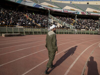 An Iranian cleric is walking along an area while veiled Iranian women are participating in a family rally to support mandatory hijab at the...