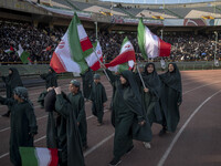 A group of young veiled women is waving Iranian flags while performing in a family rally to support mandatory hijab, at the Azadi (Freedom)...