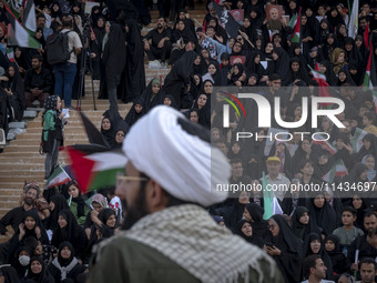 An Iranian cleric is looking at veiled women who are participating in a family rally to support mandatory hijab, at the Azadi (Freedom) Stad...